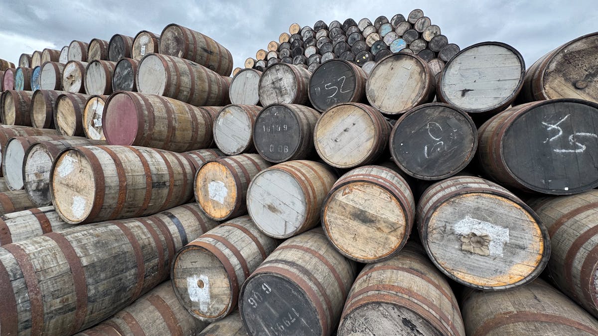 Rows of maturing whisky barrels in a traditional Speyside distillery warehouse